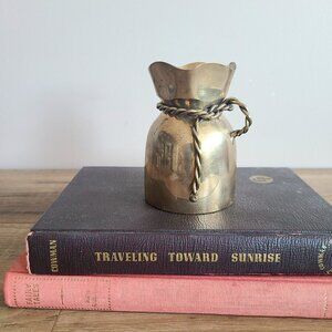 Vintage brass bud vase with robe design.